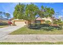 Single-story house with a well-manicured lawn and attached garage at 14031 Shady Shores Dr, Tampa, FL 33613