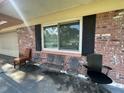 Small front porch with metal chairs and a view of the front yard at 14810 N 30Th St, Lutz, FL 33559