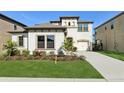 Two-story house with a three-car garage and landscaped front yard at 14838 Paddock Pond Ave, Lithia, FL 33547