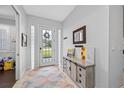 Bright entryway with a console table and decorative accents at 16130 Craigend Pl, Odessa, FL 33556