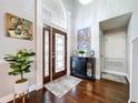 Elegant foyer with dark wood floors, decorative glass door and modern accents creating a welcoming entrance at 1632 Gray Bark Dr, Oldsmar, FL 34677