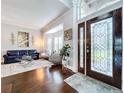 Beautiful living room with hardwood floors, large windows, and stylish furniture creating an inviting atmosphere at 1632 Gray Bark Dr, Oldsmar, FL 34677