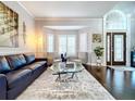 Bright and airy living room featuring hardwood floors, a comfortable seating area, and a large window at 1632 Gray Bark Dr, Oldsmar, FL 34677