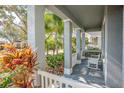 Covered front porch with white columns and a white bench at 18209 Tivoli Ln, Lutz, FL 33558