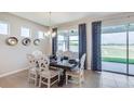 Dining room with lake view and stylish table and chairs at 18221 Beach Ranch Ter, Lakewood Ranch, FL 34211