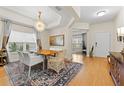 Bright dining room with wood table, chandelier, and view to entryway at 19231 Pepper Grass Dr, Tampa, FL 33647