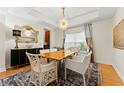 Elegant dining room with wood table, chandelier, and patterned rug at 19231 Pepper Grass Dr, Tampa, FL 33647