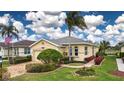 One-story home with a two-car garage, landscaped yard, and brick walkway at 1937 Sterling Glen Ct, Sun City Center, FL 33573