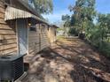 Back of house, showing AC unit and large backyard at 2008 E Annie St, Tampa, FL 33612