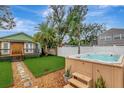 Relaxing backyard oasis featuring a hot tub and artificial turf at 2715 14Th N Ave, St Petersburg, FL 33713