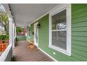 Inviting front porch with wooden flooring and white columns at 2715 14Th N Ave, St Petersburg, FL 33713