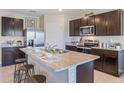 Modern kitchen with dark cabinetry, granite counters, and island at 2927 Gardiner Ln, Zephyrhills, FL 33541