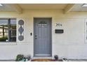 Gray front door with a small window and decorative accents at 2934 3Rd S Ave, St Petersburg, FL 33712