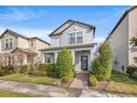 Two-story house with gray siding, landscaping, and brick walkway at 3421 Janna Grace Way, Land O Lakes, FL 34638