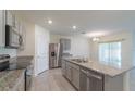 Modern kitchen featuring stainless steel appliances and granite countertops at 34219 Sorrel Mint Dr, Wesley Chapel, FL 33543