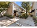 Daytime view of townhouse building with walkway and landscaping at 408 S Arrawana Ave # C4, Tampa, FL 33609