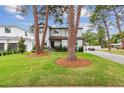 Two-story house with light gray siding, landscaping, and a paved driveway at 4224 W Kensington Ave, Tampa, FL 33629