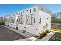 Row of modern townhomes with attached garages and landscaping at 4722 Legacy Park Dr, Tampa, FL 33611