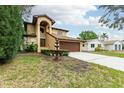 Two-story house with a brown garage door and nicely landscaped front yard at 513 Suwanee Cir, Tampa, FL 33606