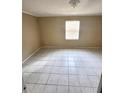 Simple bedroom with tile flooring and window at 5130 Dr Martin Luther King Jr St S, St Petersburg, FL 33705