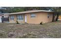 Tan single story house with white door, side view at 5130 Dr Martin Luther King Jr St S, St Petersburg, FL 33705