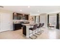 Modern kitchen with dark brown cabinets, stainless steel appliances and an island at 5322 Oxford Gray Rd, Wesley Chapel, FL 33545