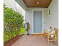 Inviting front entry with a gray door and a wooden bench at 6205 Voyagers Pl, Apollo Beach, FL 33572