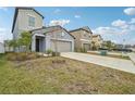 Houses with gray and beige exteriors, landscaping, and driveways at 656 Argyll Dr, Spring Hill, FL 34609