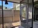 Screened front porch includes space for a plant and entrance to the front door at 7806 Amberlea Ct, Temple Terrace, FL 33637