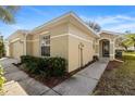 Tan house with walkway and lush landscaping at 10833 Collar Dr, San Antonio, FL 33576