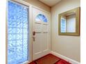 Inviting entryway with glass block windows and wood floors at 1220 10Th Sw St, Largo, FL 33770