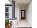 Inviting entryway with a red door and decorative glass at 16732 Mooner Plank Cir, Wimauma, FL 33598