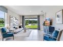 Bright living room with sliding glass doors and modern furniture at 18138 Cropside Trl, Lakewood Ranch, FL 34211