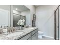 Double vanity bathroom with granite countertops and shower at 18145 Cropside Trl, Lakewood Ranch, FL 34211