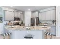 Modern kitchen with stainless steel appliances and an island at 18145 Cropside Trl, Lakewood Ranch, FL 34211