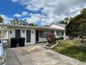 House exterior showcasing a front yard and driveway at 1824 Douglas Ave, Dunedin, FL 34698