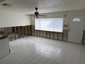 An open living room undergoing a remodel at 1824 Douglas Ave, Dunedin, FL 34698