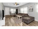 Living room with sectional sofa, large TV, and hardwood floors at 206 N Himes Ave, Tampa, FL 33609