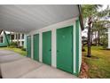 Green storage units with white trim, located under a covered carport at 2561 Royal Pines Cir # 14H, Clearwater, FL 33763