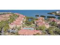 Aerial view showcasing community, waterfront, and resort-style pool at 2724 Via Murano # 631, Clearwater, FL 33764