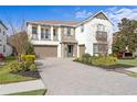 Two-story home with stone accents and a three-car garage at 28475 Marsciano Ln, Wesley Chapel, FL 33543