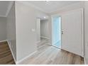 Bright entryway with wood-look flooring and updated interior doors at 2866 Countrybrook Dr # 15, Palm Harbor, FL 34684