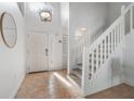 Bright entryway with hardwood floors, a white door, and a staircase at 2993 Shannon Cir, Palm Harbor, FL 34684