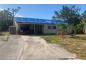 One-story house with tarp-covered roof, needs repairs at 3120 Smith Ave, Bradenton, FL 34207