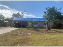 One-story house with tarp-covered roof, needs repairs at 3120 Smith Ave, Bradenton, FL 34207