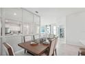 Dining room with mirrored wall and view into living room at 31540 Ancient Sage Rd, Wesley Chapel, FL 33545