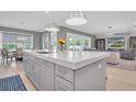 Modern kitchen with large island, quartz countertops, and stainless steel appliances at 3213 W Fair Oaks Ave, Tampa, FL 33611