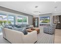 Open living area with sectional sofa, fireplace, and large TV at 3213 W Fair Oaks Ave, Tampa, FL 33611