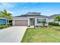 Two-story house with gray siding, landscaping, and a two-car garage at 3322 Woodmont Dr, Parrish, FL 34219