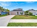 Two-story home with gray siding, neutral accents, and a two-car garage at 3322 Woodmont Dr, Parrish, FL 34219